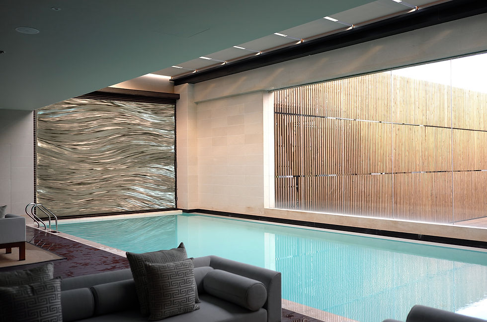 A painting of gold elaf with ripples and undulating waves set in a hotel interior - curated by Artelier art consultancy