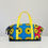 Thumbnail: Sac de voyage coloré avec des motifs circulaires, poignées jaunes, élégant et moderne.