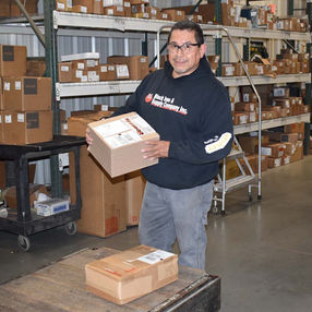 Block Iron & Supply employee moving boxes