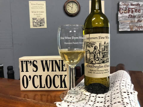 Hammen Family Orchard & Winery It's Wine O' Clock signe with a glass of Hammen wine and a bottle of wine
