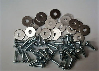 Metal washers and screws scattered together on a white surface.