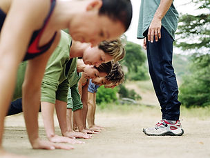 ladies doing push ups under supervision