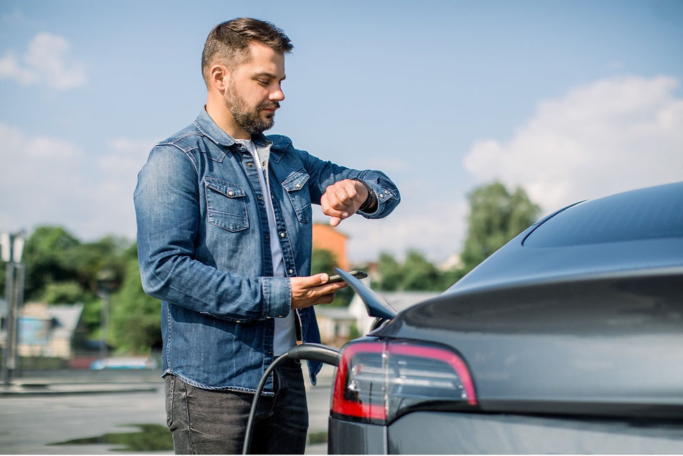 Man Waiting While Charging His Car