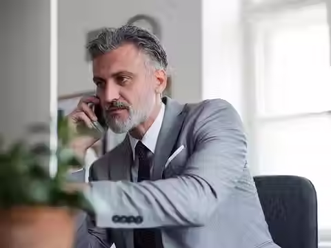 A business owner on the phone talking to someone about building their business structurally instead of quick, fast and in a hurry