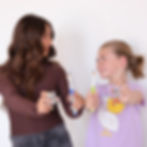 Two girls holding toothbrushes at a dental clinic in lincoln
