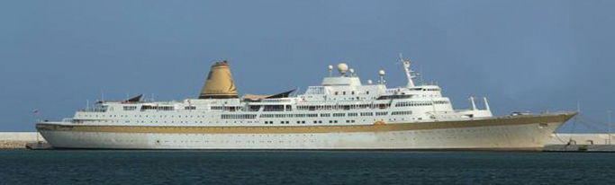 Large white cruise ship on water with blue sky background qps-marine-ships