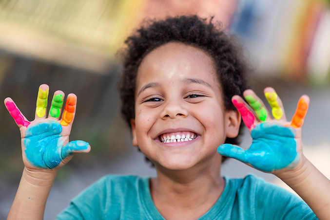 beautiful happy boy with painted hands.jpg