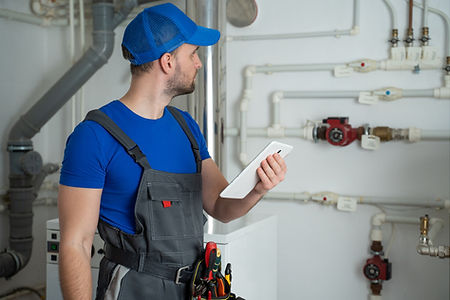 Plumber checks on ipad about gas fitting.