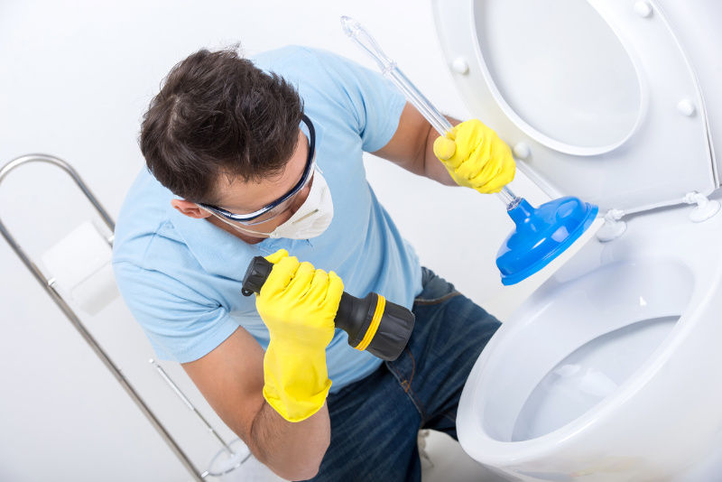 A man try to fix toilet blocked.