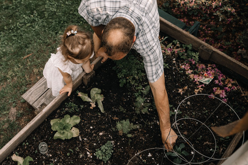 grandfather shows girl the garden