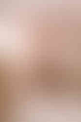 a couple sits in the nursery of their newborn daughter