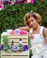 Picutre of the found of Kalahni's Treasures sitting beside her products.