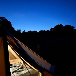 Glamping tent at night, light up inside.
