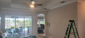 Before photo of a residential living room and tray ceiling prepped for professional interior painting on Ponce de Leon Trail in Port Charlotte, Florida by Best Paint Lines.