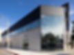Modern commercial building with glass windows showing the exterior of 1622 N Highland