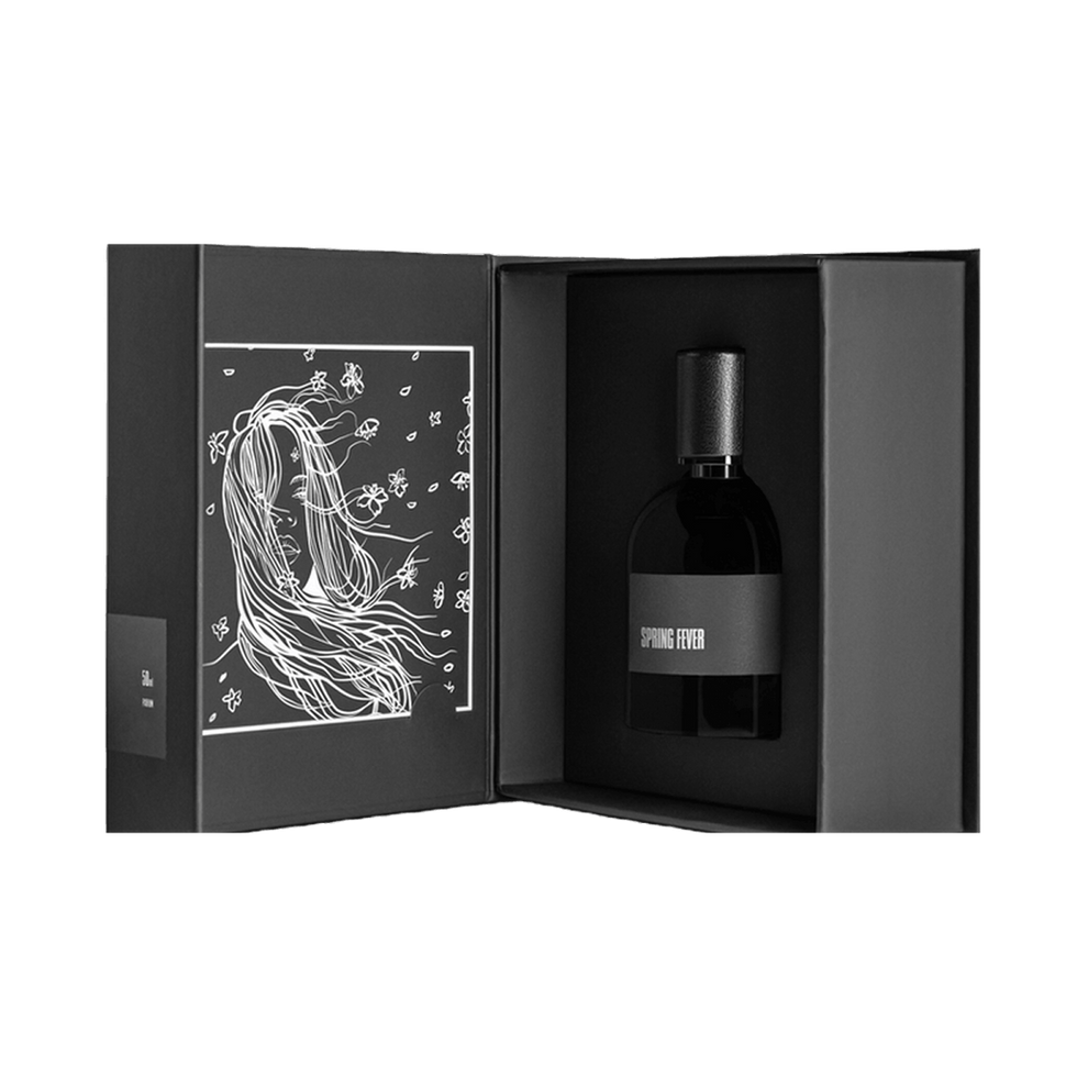 Niche citrus perfume in a black box with line art.