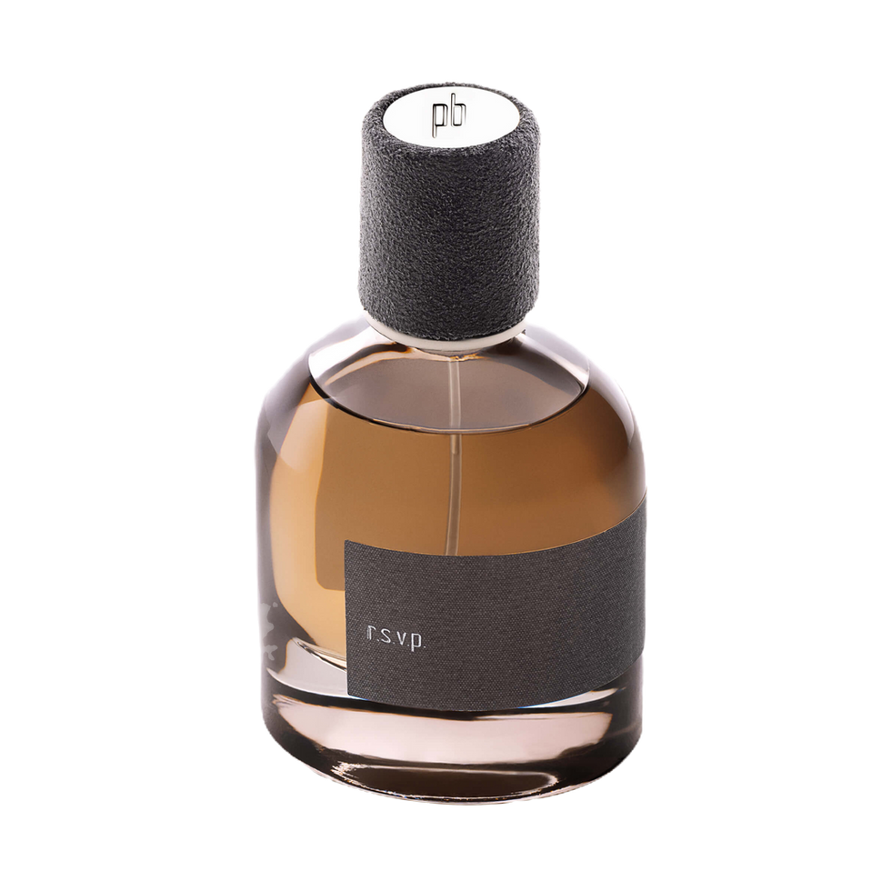 Niche citrus perfume bottle with RSVP label and gray cap