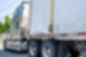 Beige industrial grade big rig semi truck tractor with broken dry van semi trailer fastene