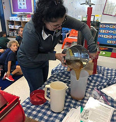 Hands-on agricultural lesson at Quiver Farm teaching traditional farming and food production experiences