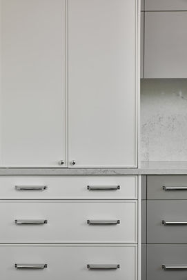 White kitchen cupboards with silver hardware