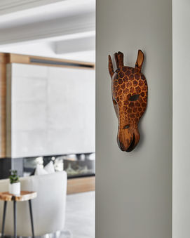 Giraffe mask hung on a wall