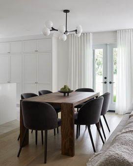 Multi-globe light pendant above a six person dining table 