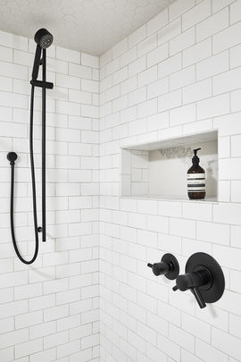 White tiled shower with black hardware
