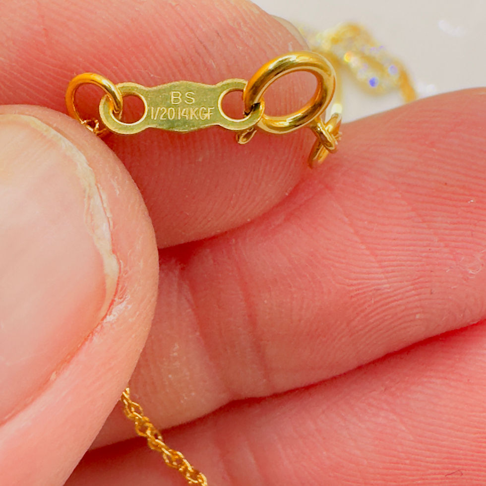 Thumbnail: Fingers hold gold necklace clasp with "BS 1/20 10KGF" stamp.
