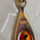 Thumbnail: Close-up of a silver pendant with amber stone and 
