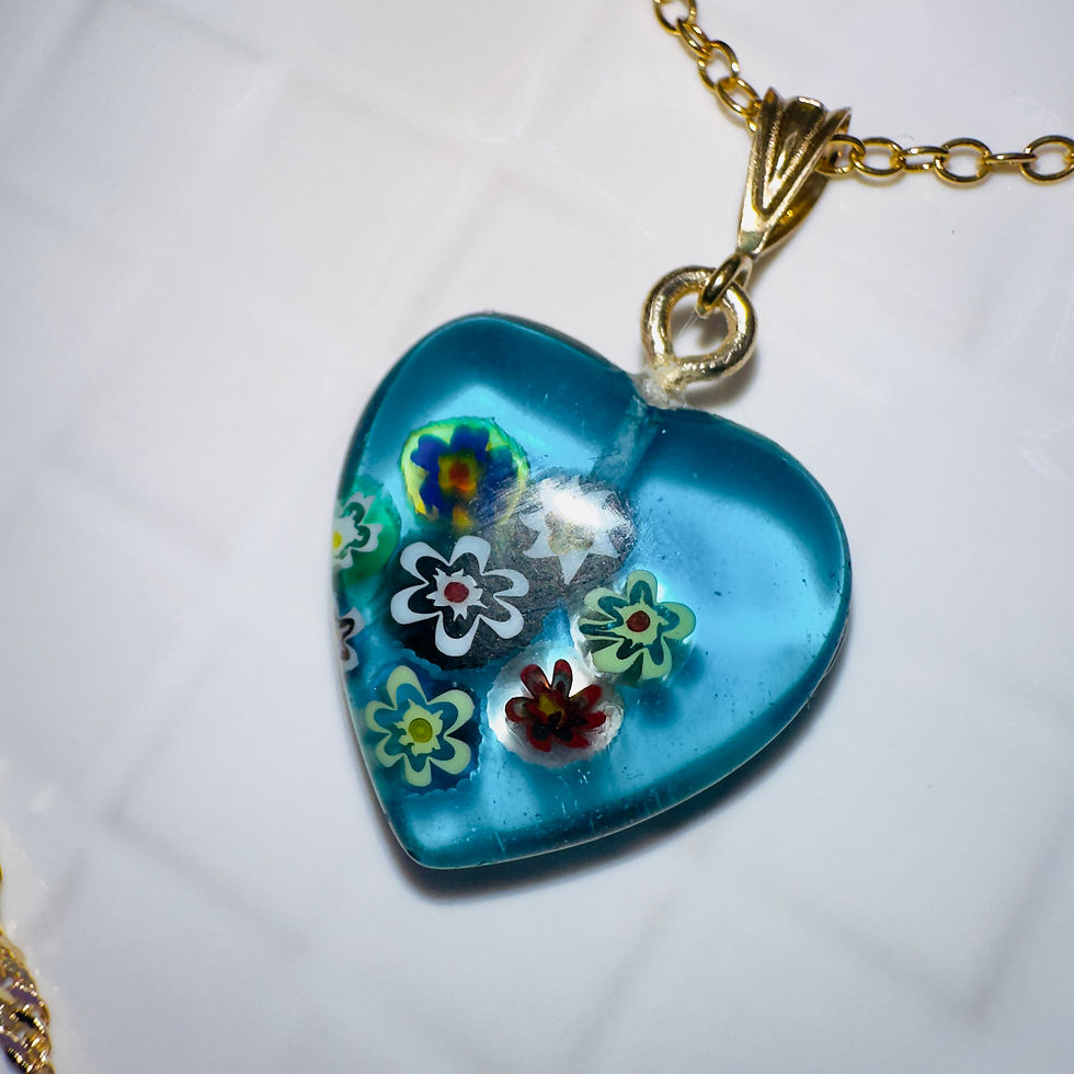 Blue heart pendant with colorful flower details on a gold chain