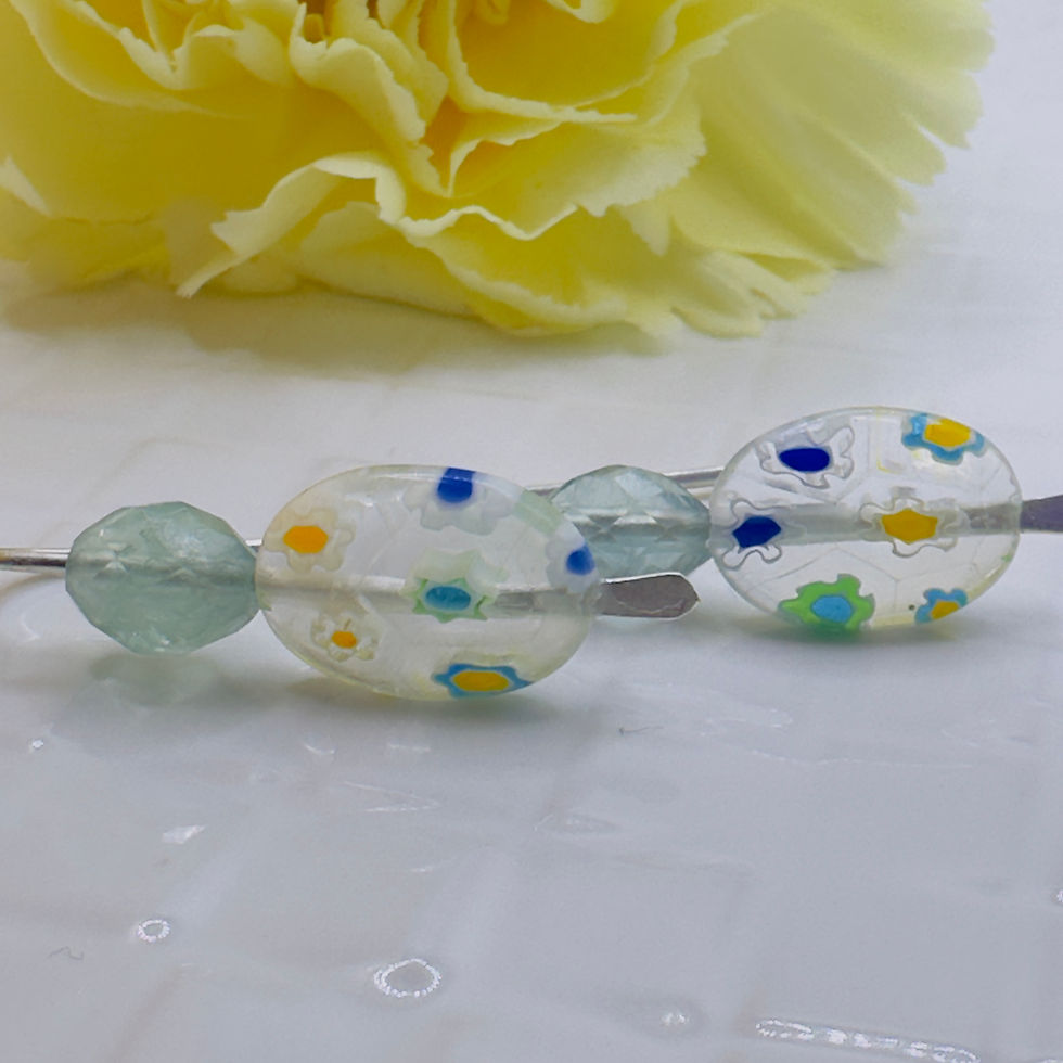Clear glass beads with colorful flower patterns, green bead