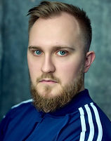 A photograph headshot of actor Adam Gower which when clicked takes you to the actor's Spotlight page