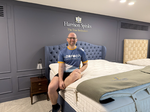 David Labuschagne, Head of Marketing at Harrison Spinks, sits on one of their beds.