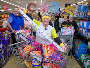 A group of people fulling up their trollies in Aldi, supporting the charity CHAS.