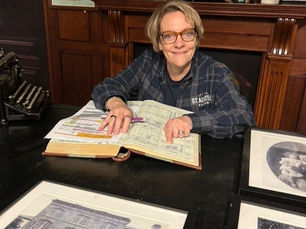 Georgina Young, Brewing Director at St Austell Brewery, sits at her desk looking through 175 years of St Austell's history books.