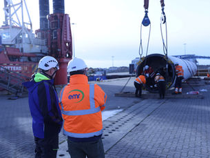 A long wind turbine laying down to deconstruct components.