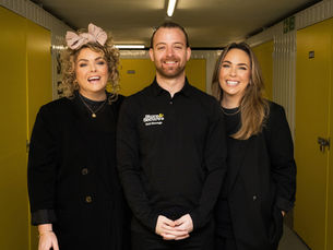Three staff from the company Store and Secure, are standing together smiling.