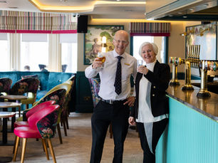 Brother and sister standing together at their hotel bar.