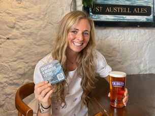 Emily Coon, Sustainability Manager at St Austell Brewery, holding their first biodegradable beer mat.