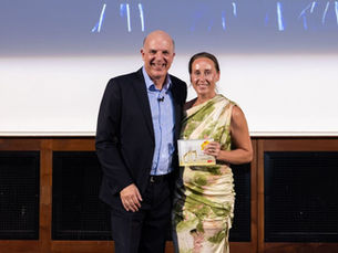 A photo of Hannah Tilley from Chartway Janitorial, receiving the trophy for The People's Choice Award from the Founder of Family Business United, Paul Andrews, for London & the South East region.