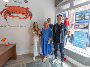 A family-run holiday agency standing together in their office, Crabpot Cottages, Cromer.