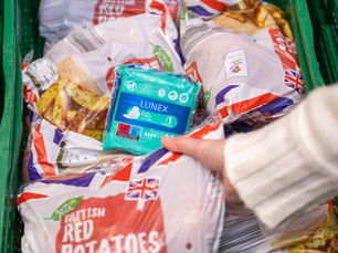 Aldi shopping trolley filled with food and period products.