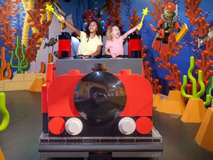Children sitting on a stationary giant train. 