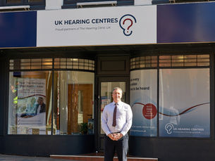 Anthony Berg, founder of The Hearing Clinic UK, is standing outside his clinic, in Congleton.