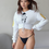 Thumbnail: Kinky Couture Vixen lace-up corset crop hoodie — white quilted backless hoodie with black sketch design and gold Vixen sleeve