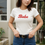Thumbnail: Women’s Kinky Couture “Babe” T-shirt featuring a bold retro script logo in contrasting color. Playful, confident women’s tee