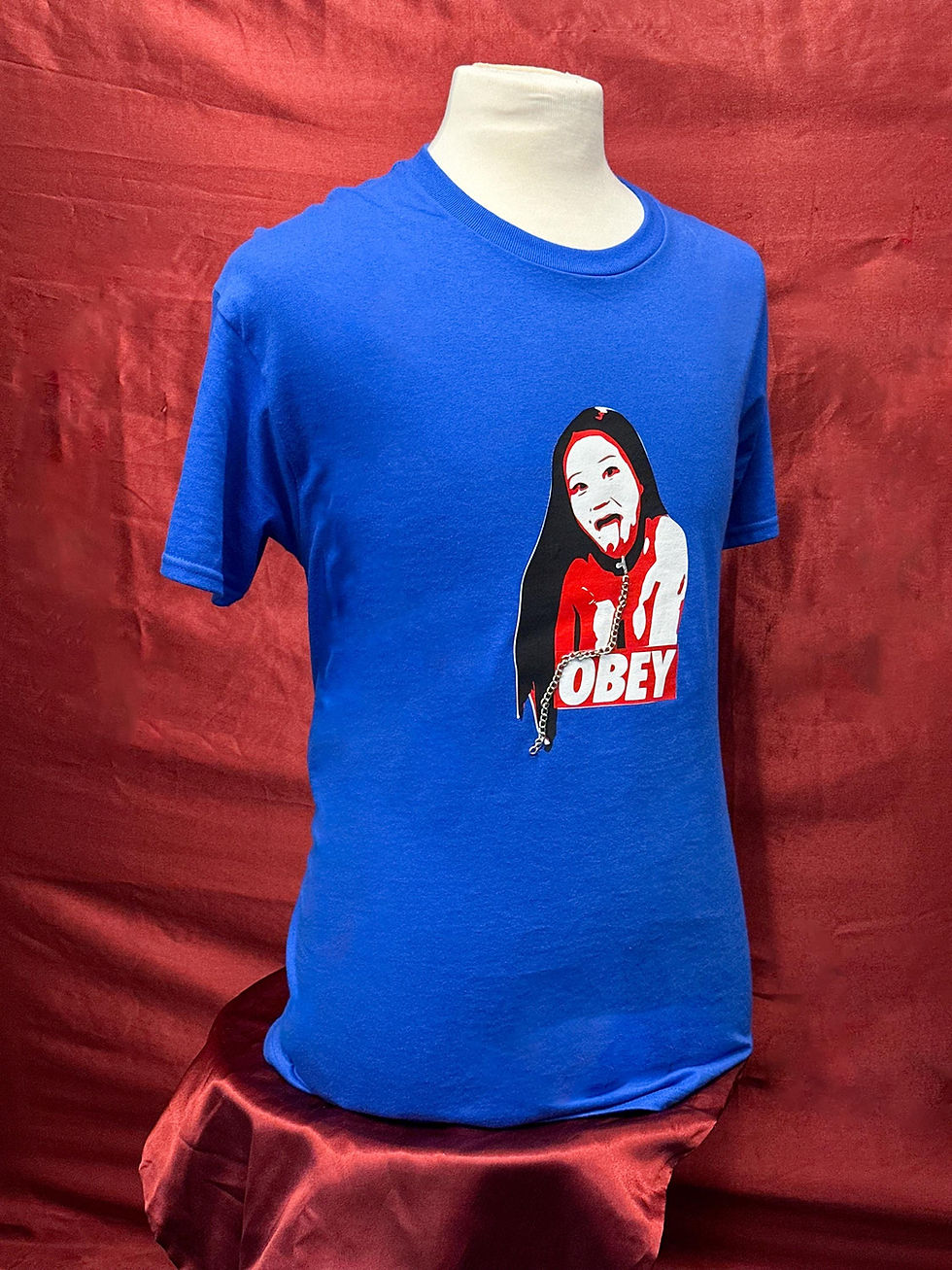 Thumbnail: Kinky Couture OBEY BDSM-themed men’s T-shirt — blue heavy cotton tee with red and white submissive girl graphic and real meta