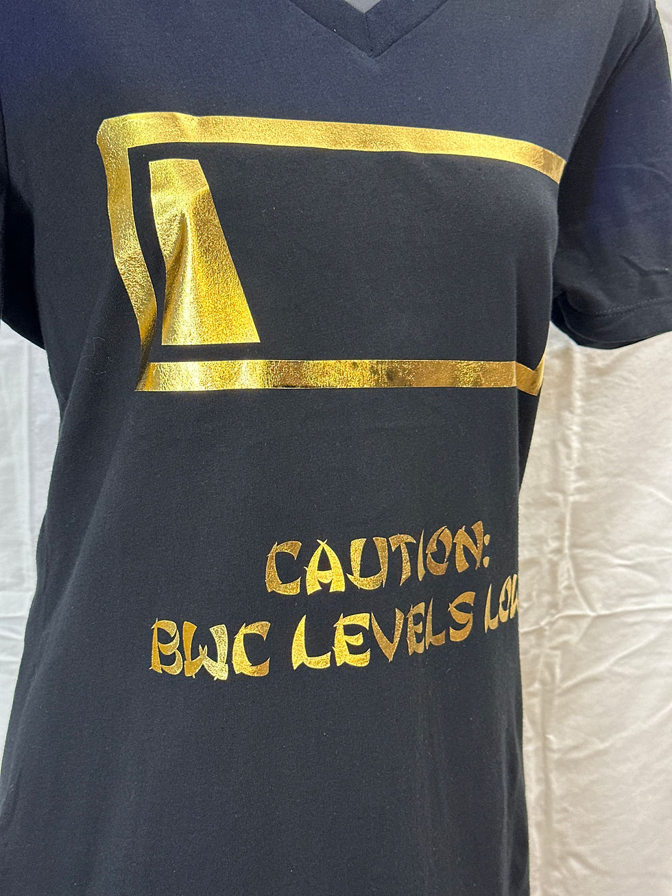 Thumbnail: Women’s Kinky Couture “Caution: BWC Levels Low” T-shirt featuring bold caution label design in yellow and black. Playful, sex