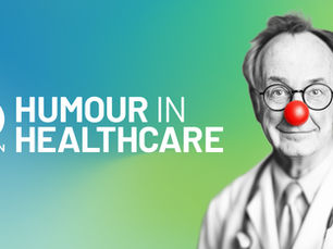 A male doctor looking to camera wearing a red nose