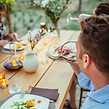 Guests enjoying dinner and wine in the garden at Villa Oliveto, a luxury villa in Tuscany 